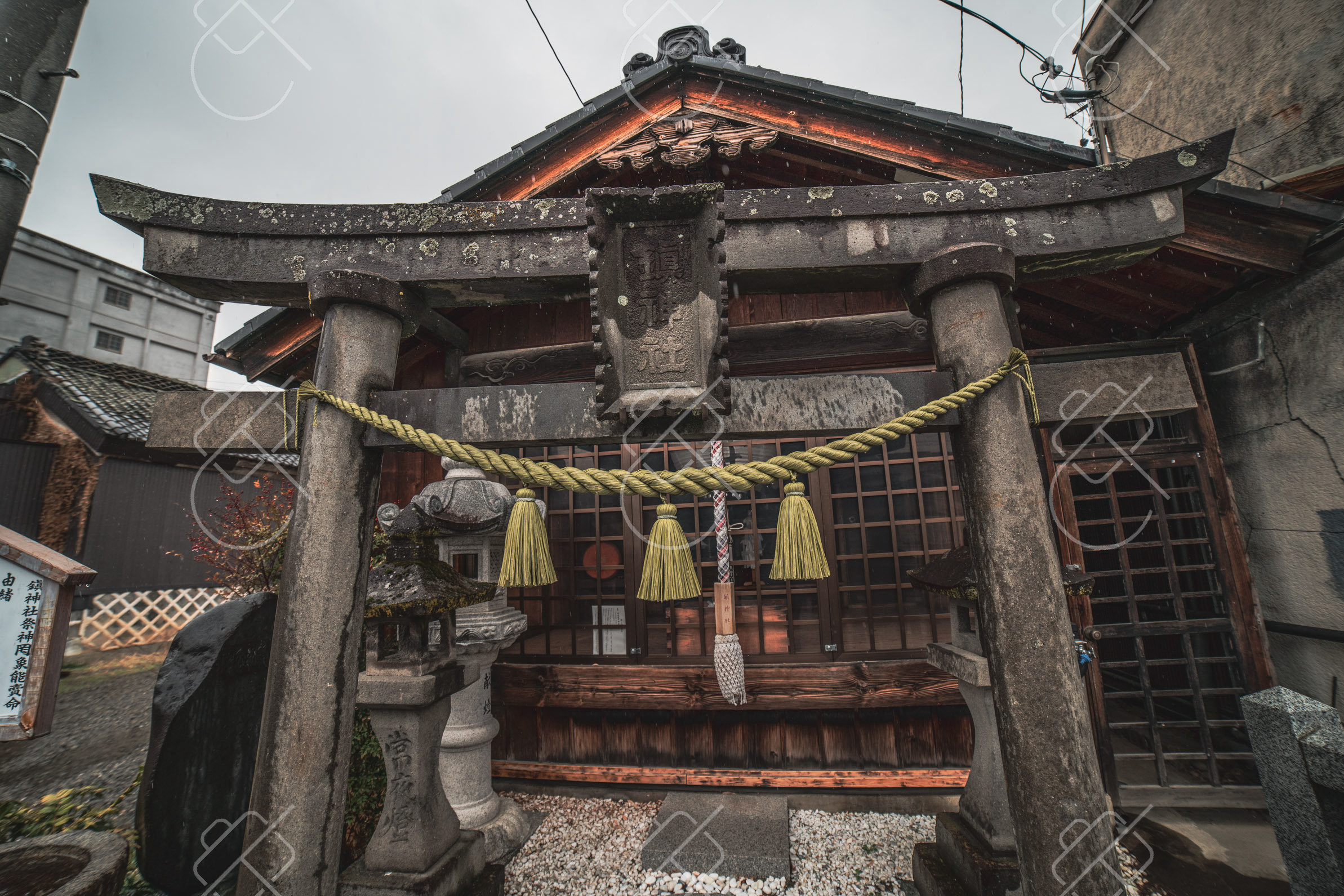 A small back-street shrine with its shimenawa rope and stone torii — Matsumoto, fine art travel photography print available from Clever Tourists