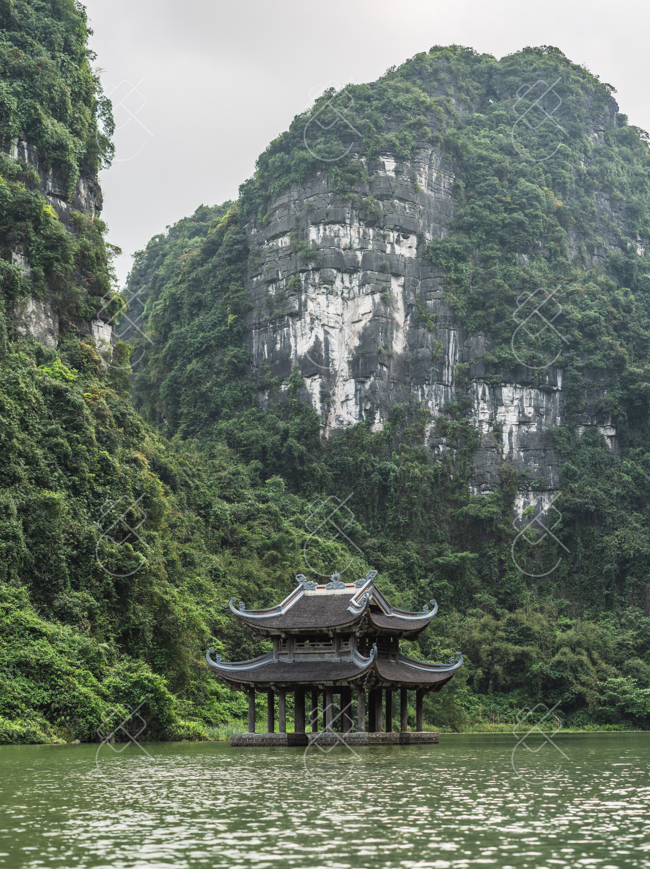 Pagoda roofs rising beneath Ninh Binh's limestone walls — Tam Coc, Bich Dong & the countryside, fine art travel photography print available from Clever Tourists