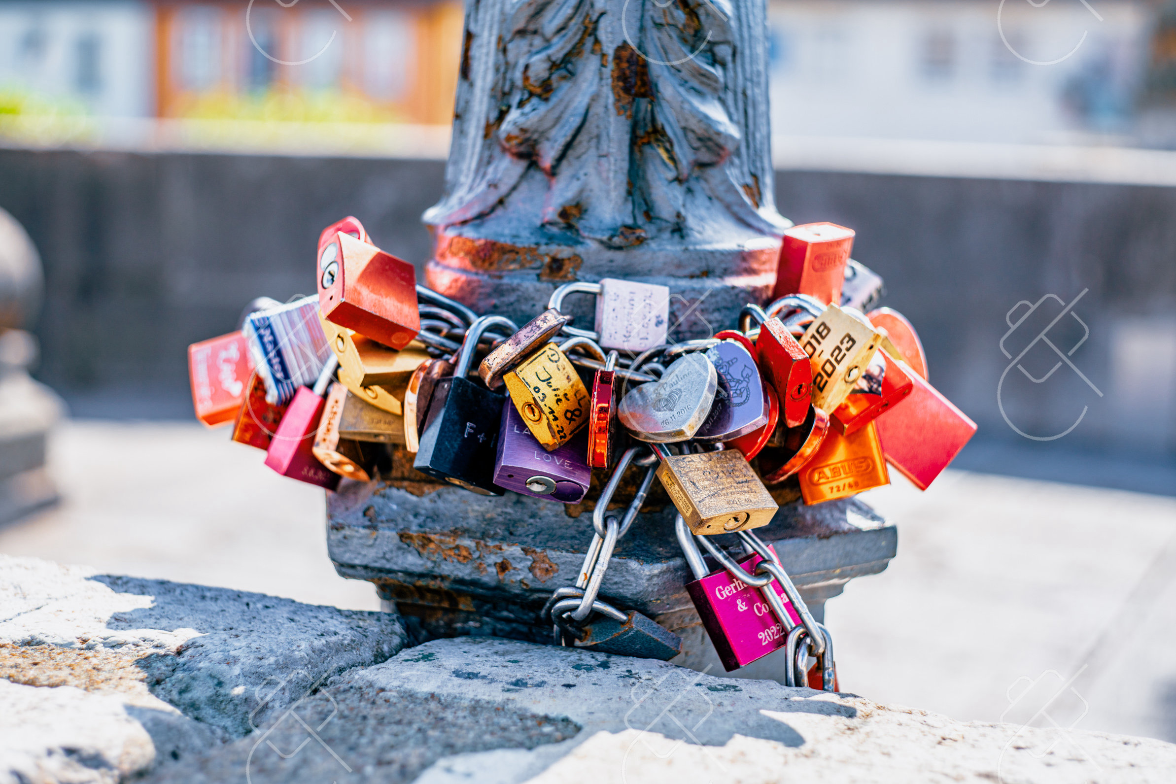 Love locks clustered on a lamppost along the Old Main Bridge — Würzburg, fine art travel photography print available from Clever Tourists