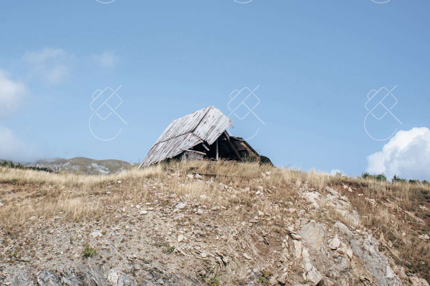 A weathered stone shelter on an exposed highland ridge near Nikšić — Nikšić, fine art travel photography print available from Clever Tourists