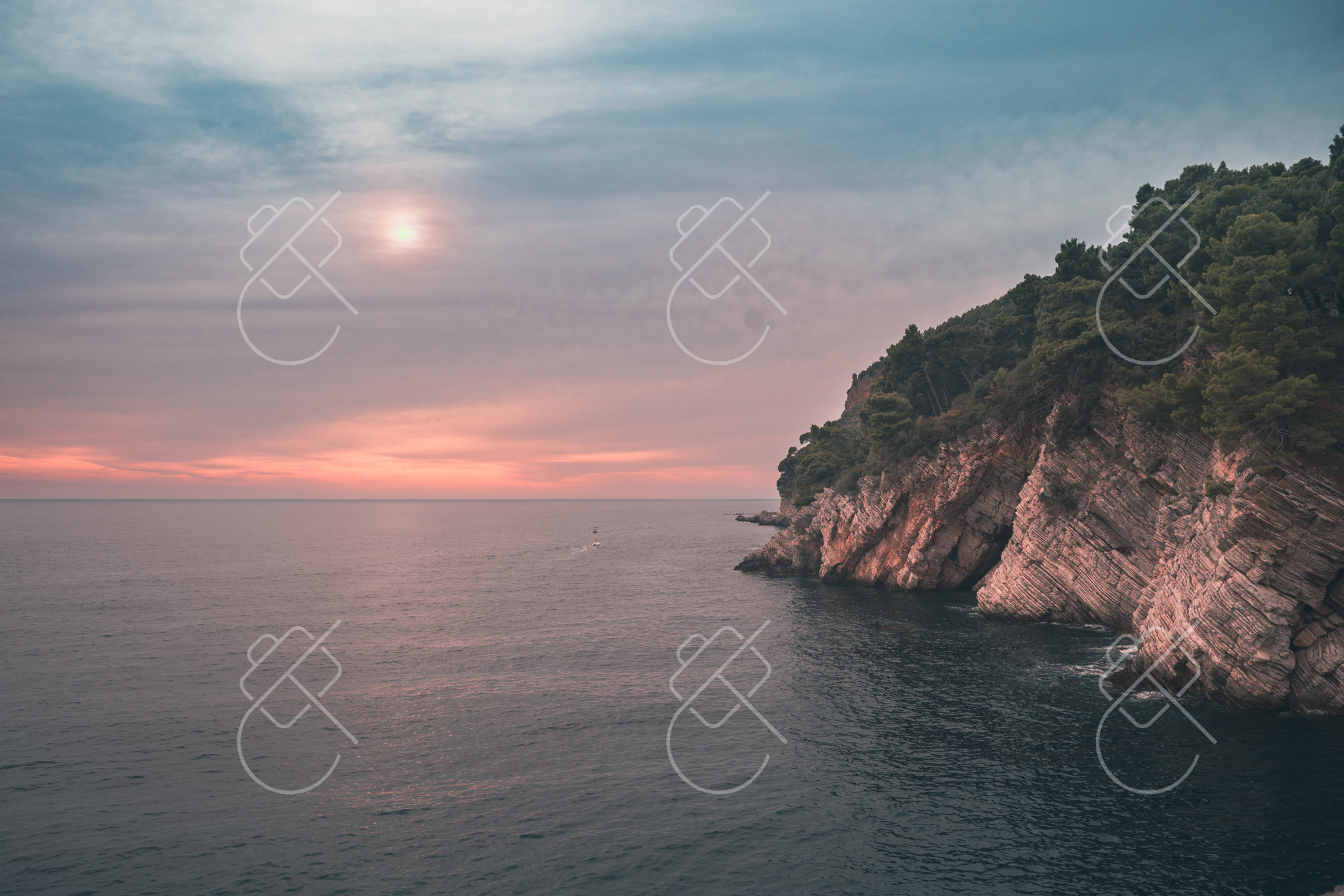 The rocky coastline near Petrovac lit by a pink sunset — Petrovac, fine art travel photography print available from Clever Tourists