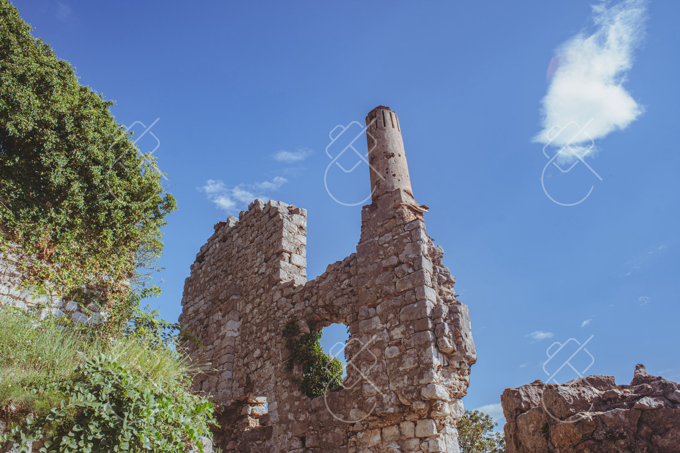 An ivy-covered ruin tower against a clear blue sky — Stari Bar, fine art travel photography print available from Clever Tourists